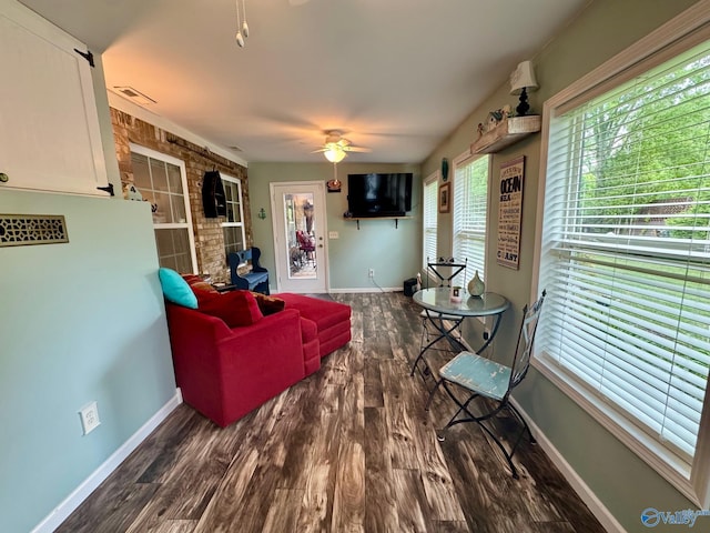 living room featuring baseboards, a ceiling fan, wood finished floors, and visible vents