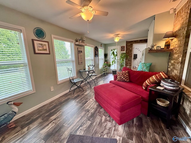 living area with baseboards, a ceiling fan, and wood finished floors