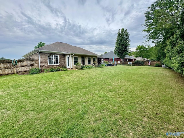 view of front of property with a fenced backyard and a front yard