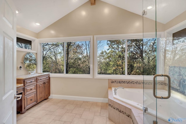 bathroom with vanity, tiled tub, and high vaulted ceiling