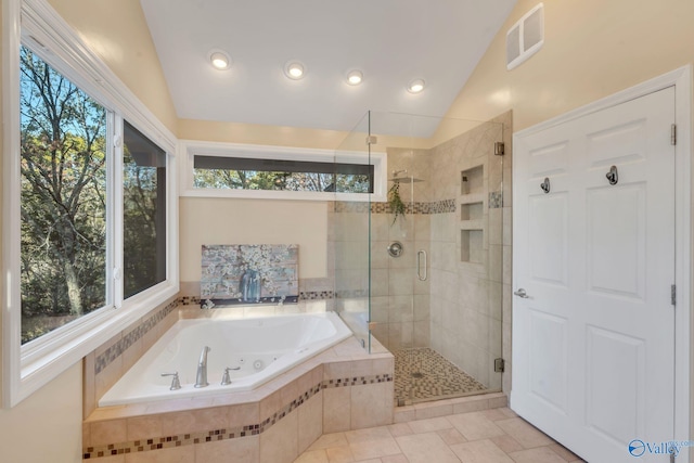 bathroom featuring a healthy amount of sunlight, shower with separate bathtub, and lofted ceiling