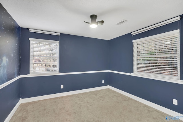 unfurnished room featuring carpet and a textured ceiling