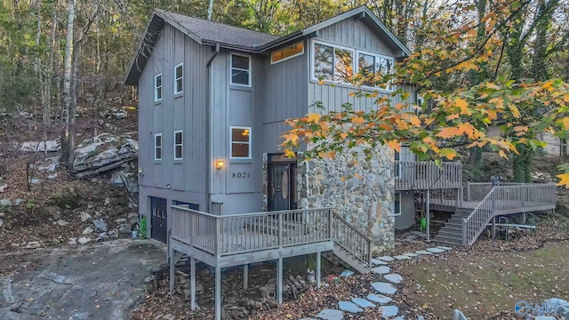 back of property with a wooden deck