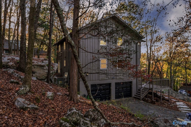 view of home's exterior featuring a wooden deck and a garage