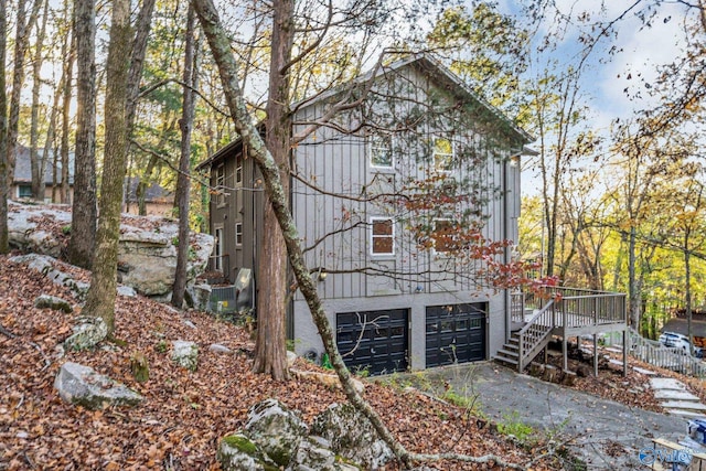 view of property exterior featuring a wooden deck and a garage