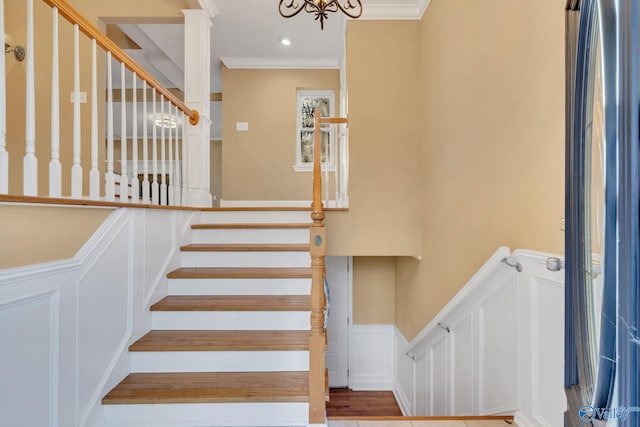 stairway featuring wood-type flooring and ornamental molding