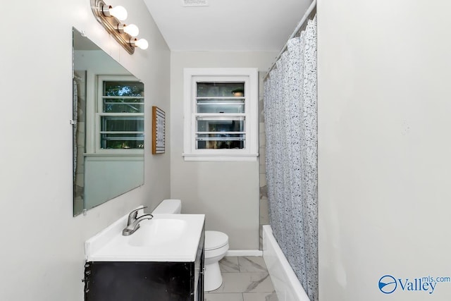 bathroom with marble finish floor, toilet, vanity, and baseboards