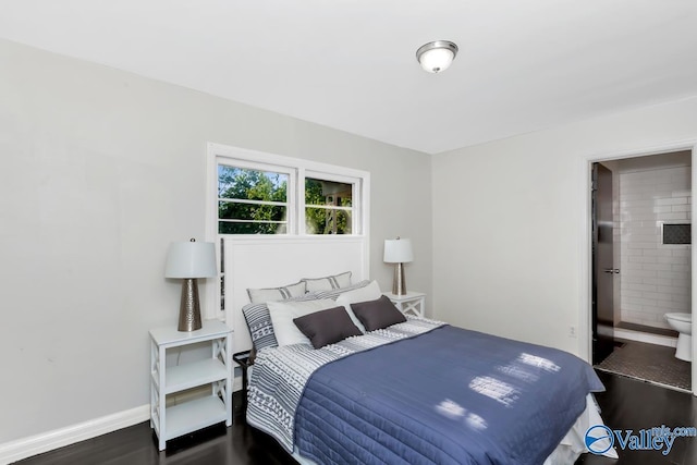 bedroom with wood finished floors, baseboards, and ensuite bathroom