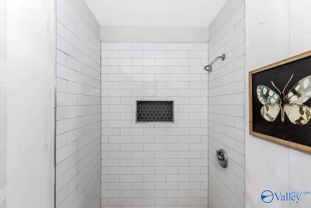 full bath with a tile shower