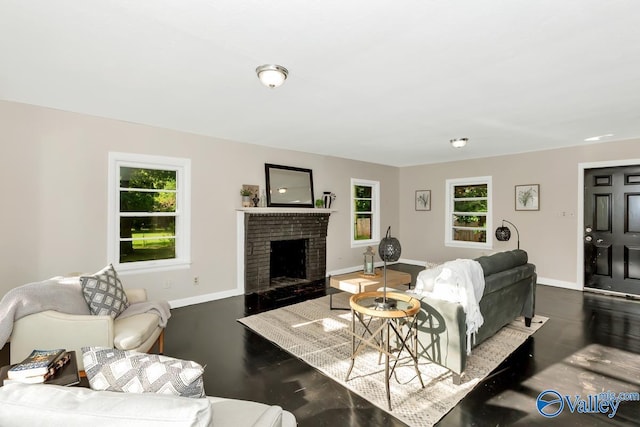 living area featuring a brick fireplace, plenty of natural light, wood finished floors, and baseboards