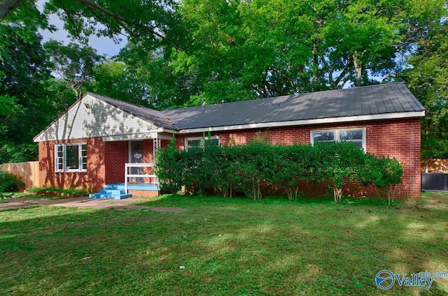 single story home featuring a front lawn and brick siding