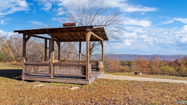 view of yard featuring a deck with mountain view