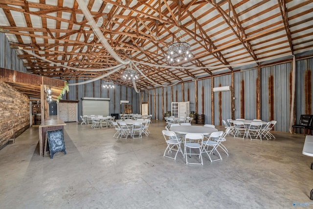 misc room featuring concrete flooring and high vaulted ceiling