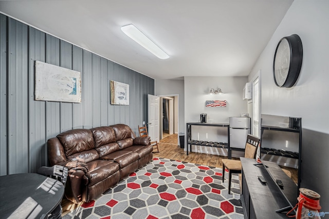 living room featuring wood walls and hardwood / wood-style floors