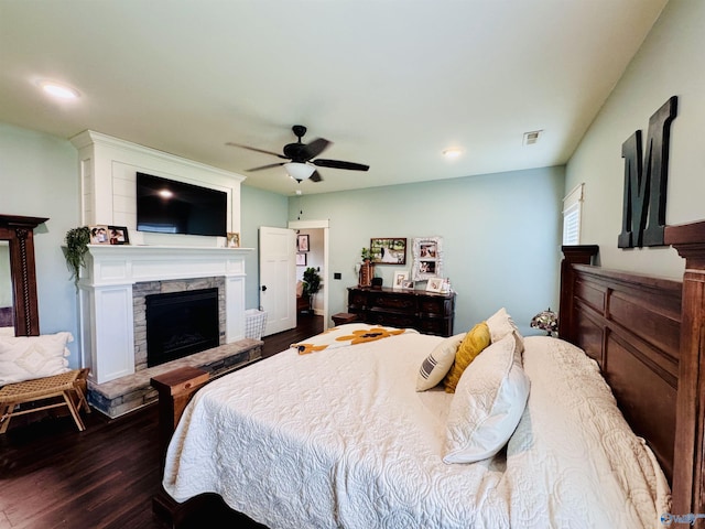 624 2nd Ave S, Loretto, TN 38469 - bedroom with dark wood-style floors, a stone fireplace, a ceiling fan, and recessed lighting