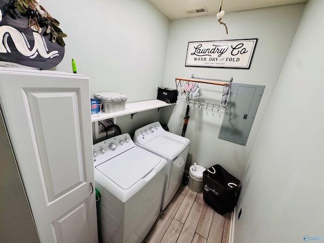 624 2nd Ave S, Loretto, TN 38469 - washroom featuring separate washer and dryer, electric panel, and light wood finished floors