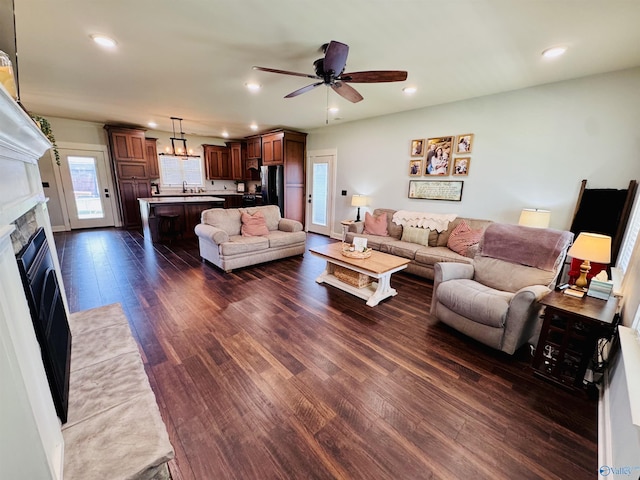 624 2nd Ave S, Loretto, TN 38469 - living room with dark wood-style floors, recessed lighting, ceiling fan, and a fireplace with flush hearth