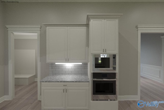 kitchen featuring stainless steel oven, light stone counters, light hardwood / wood-style flooring, decorative backsplash, and white cabinets