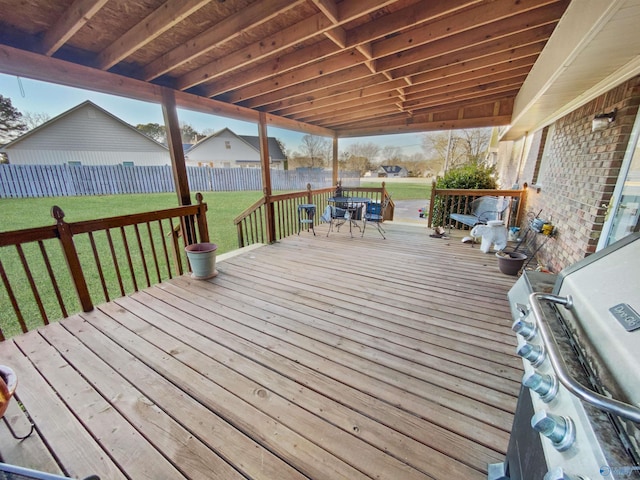 wooden terrace with area for grilling and a yard