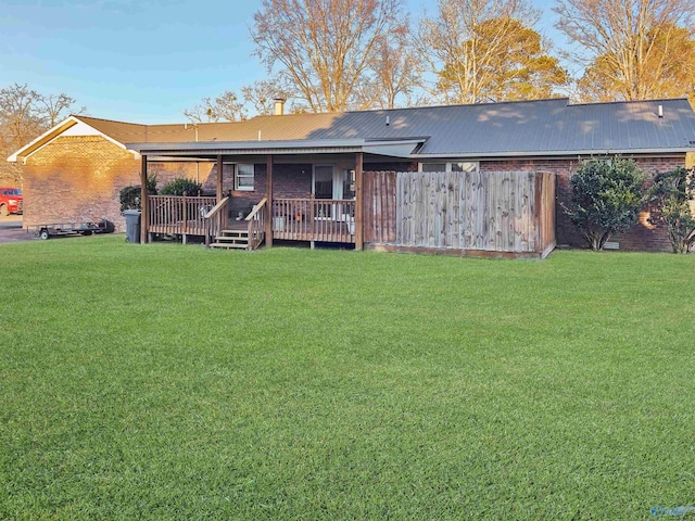 back of house featuring a lawn