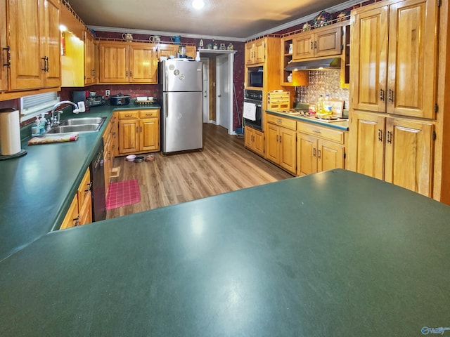 kitchen featuring tasteful backsplash, sink, ornamental molding, light hardwood / wood-style floors, and black appliances