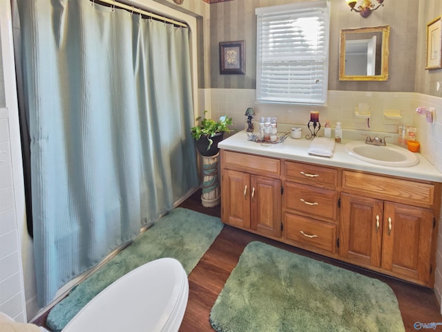 bathroom featuring vanity, hardwood / wood-style floors, walk in shower, and toilet