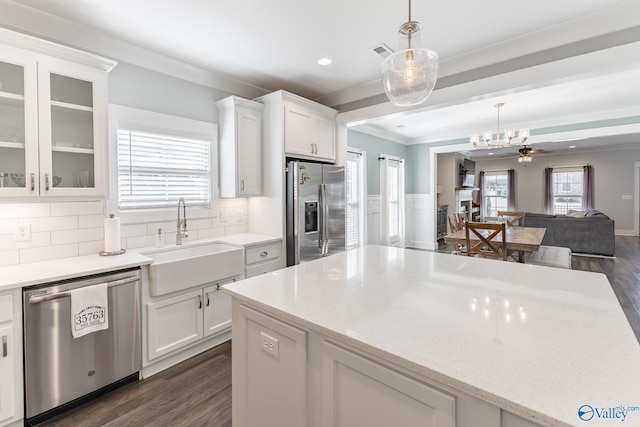 kitchen featuring white cabinets, sink, ceiling fan, decorative backsplash, and stainless steel appliances