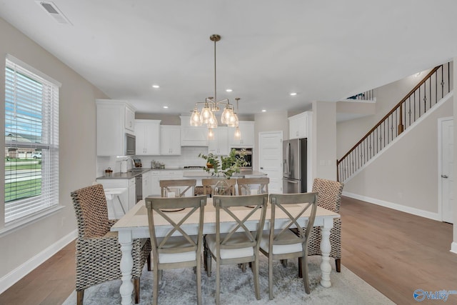 dining space with light hardwood / wood-style flooring