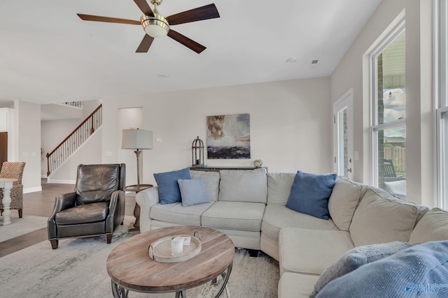 living room featuring a wealth of natural light, light hardwood / wood-style floors, and ceiling fan