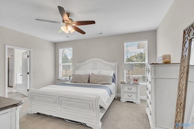 carpeted bedroom featuring connected bathroom and ceiling fan