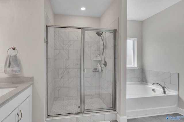 bathroom with tile patterned flooring, vanity, and plus walk in shower