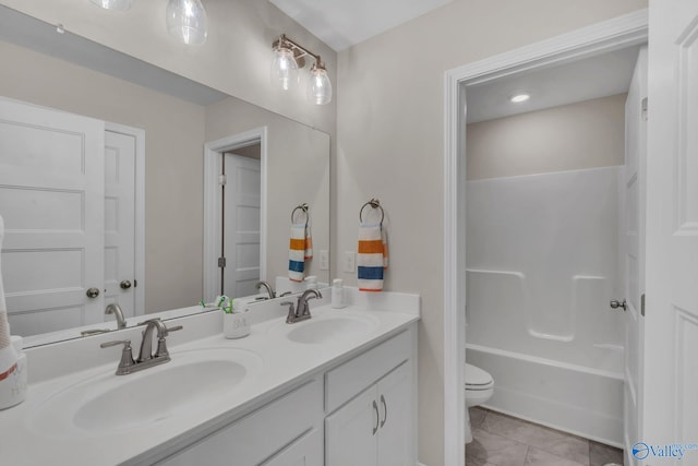 full bathroom featuring vanity, tile patterned floors, toilet, and bathtub / shower combination