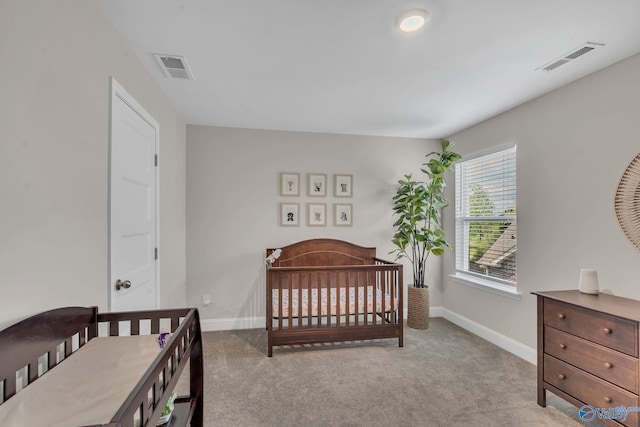 carpeted bedroom with a nursery area