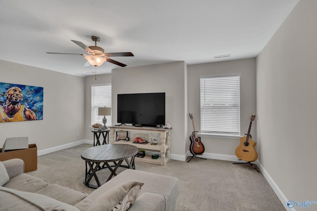 carpeted living room featuring a wealth of natural light and ceiling fan