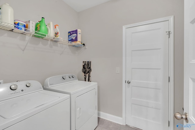 laundry room with light tile patterned flooring and separate washer and dryer