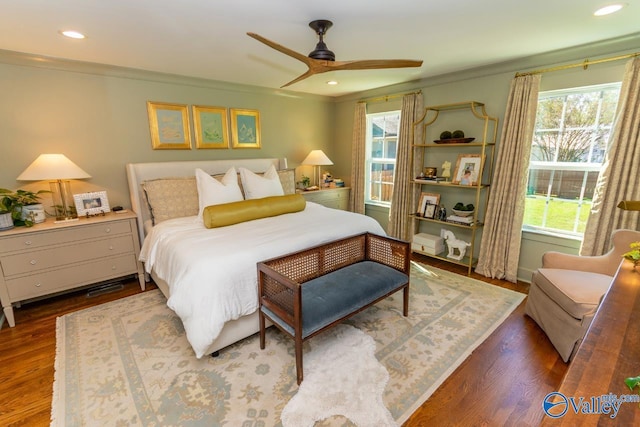 bedroom with ceiling fan, dark wood-type flooring, and ornamental molding