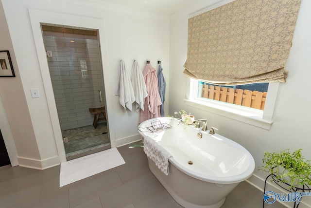 bathroom with tile patterned flooring and separate shower and tub