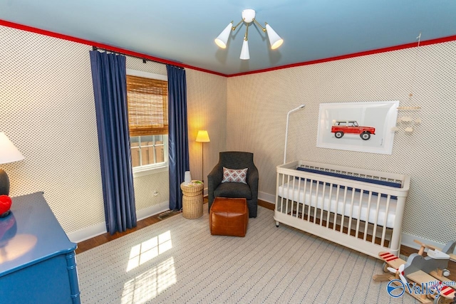 bedroom featuring a notable chandelier and a nursery area