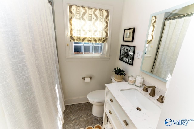 bathroom with vanity, toilet, and walk in shower