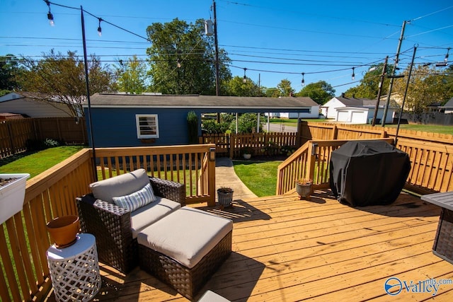 wooden deck with an outbuilding, a yard, and grilling area