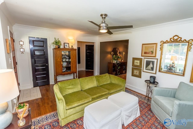 living room with ceiling fan, dark hardwood / wood-style flooring, and crown molding