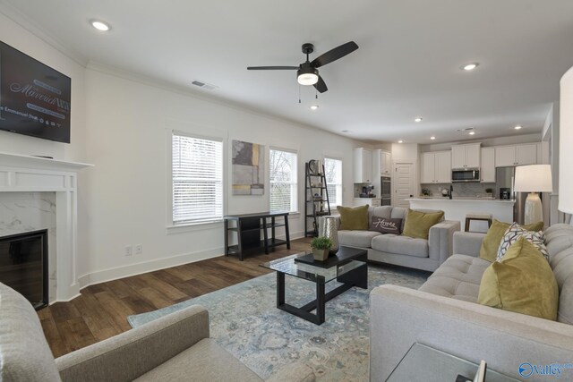 24139 Patriot Dr, Athens, AL 35613 - living room with dark hardwood / wood-style flooring, a fireplace, ornamental molding, and ceiling fan