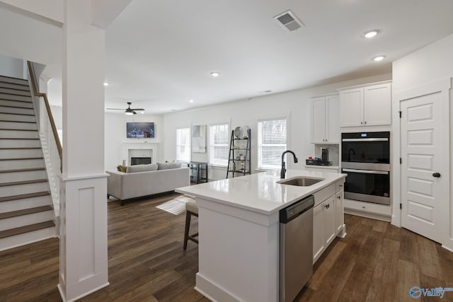 24139 Patriot Dr, Athens, AL 35613 - kitchen with white cabinetry, stainless steel dishwasher, a kitchen island with sink, and sink