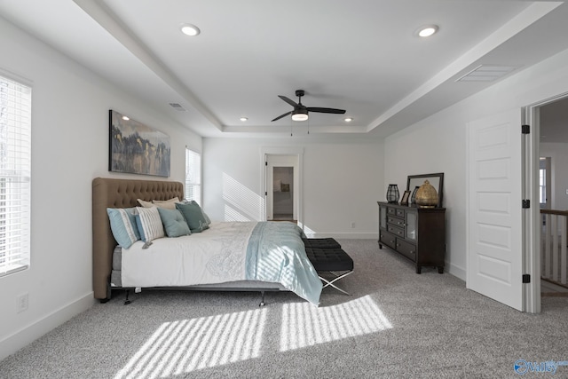 24139 Patriot Dr, Athens, AL 35613 - carpeted bedroom featuring a raised ceiling, ceiling fan, and multiple windows