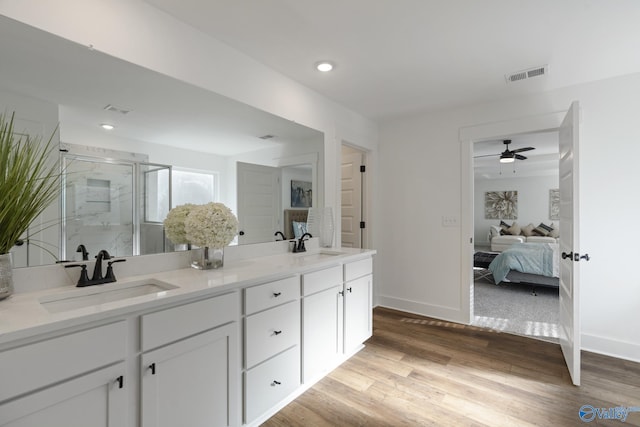 24139 Patriot Dr, Athens, AL 35613 - bathroom with hardwood / wood-style flooring, ceiling fan, vanity, and a shower with shower door
