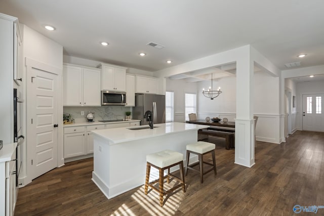 24139 Patriot Dr, Athens, AL 35613 - kitchen featuring sink, white cabinetry, decorative light fixtures, stainless steel appliances, and a kitchen island with sink