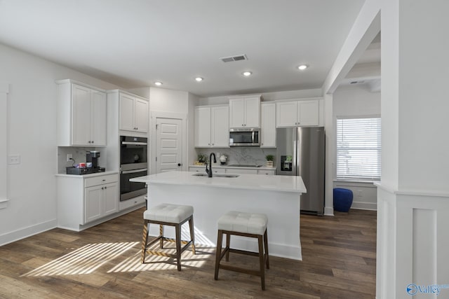 24139 Patriot Dr, Athens, AL 35613 - kitchen featuring white cabinetry, sink, a center island with sink, and appliances with stainless steel finishes