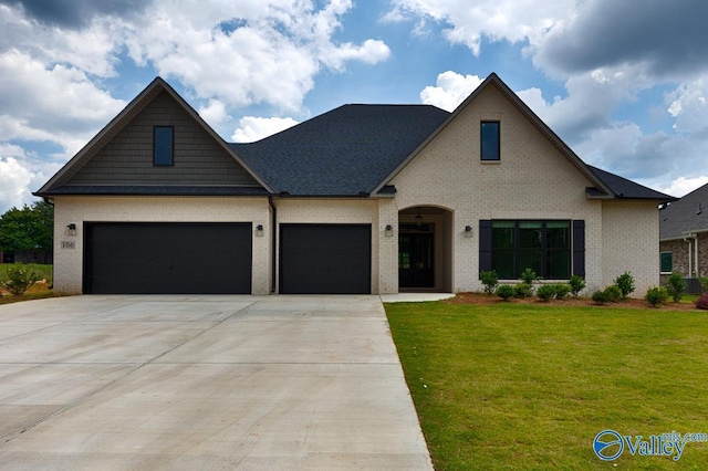 view of front of house featuring a front yard and a garage