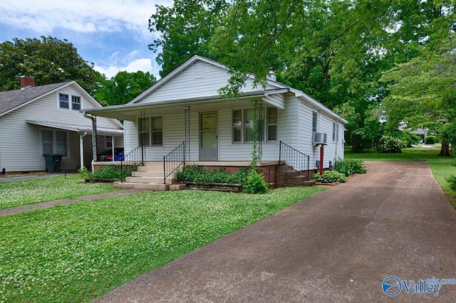 bungalow-style house with covered porch and a front lawn