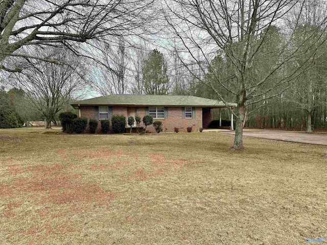 ranch-style house featuring a front yard and a carport